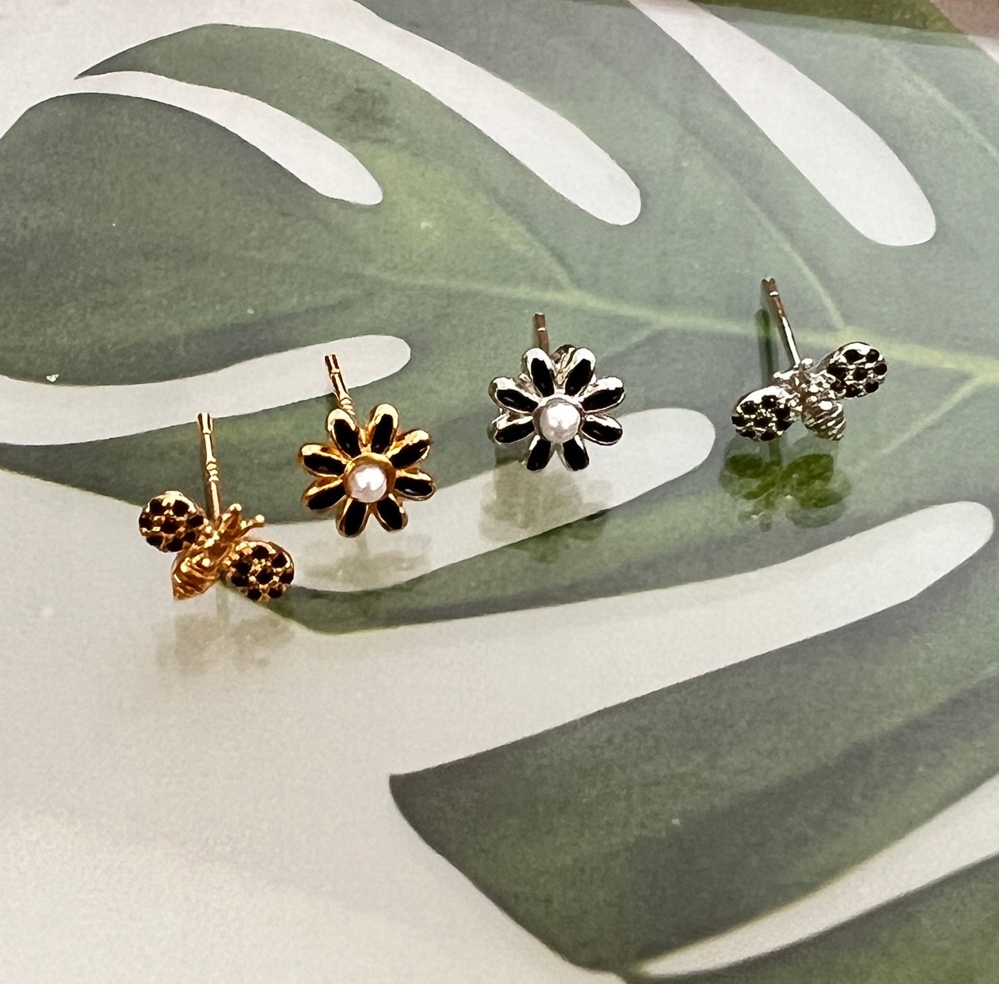 Black cubic setting tiny honey bee and daisy flower earrings